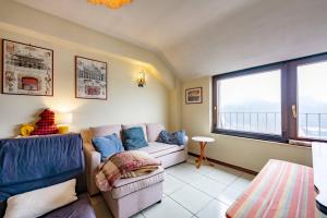 a living room with a couch and a window at Guest Art Campitello Matese in Campobasso