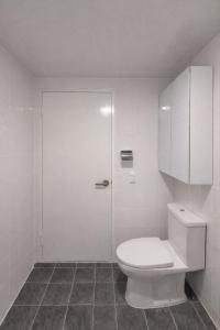 a white bathroom with a toilet and a cabinet at 메종 블랑 서울 in Seoul +23 photos