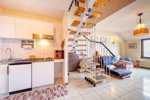 a kitchen with a spiral staircase and a living room at Guest Art Campitello Matese in Campobasso