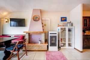 a living room with a fireplace with a table and chairs at Guest Art Campitello Matese in Campobasso
