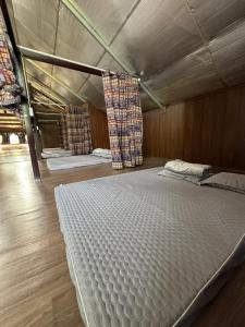 a large bed in a room with at Loopmoto Riverside Homestay in Làng Lap +27 photos