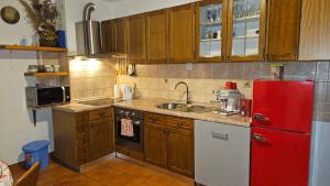 a kitchen with a red refrigerator and a sink at Apartman CaCO3 - Potpuno opremljen stan u blizini Plitvičkih jezera in Korenica