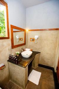 a bathroom with a sink and a counter with a sink at Viento - Habarana in Habarana +28 photos