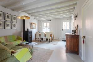 a living room with a couch and a table at Clos Chartrain in La Chartre-sur-le-Loir