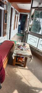 a room with a table and a bed and a table sidx sidx at indrapuri homestay in Darjeeling +23 photos