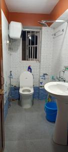 a bathroom with a toilet and a sink at indrapuri homestay in Darjeeling
