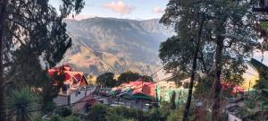 a view of a town with a mountain in the background at indrapuri homestay in Darjeeling