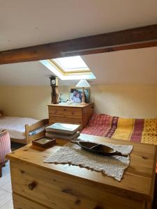 a bedroom with a bed and a table with a mirror at Oxygène in Lasseube