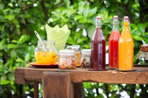 a table with bottles and jars of drinks on it at Bed & Breakfast Tiffany in Domodossola