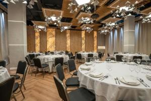 a conference room with tables and chairs and chandeliers at Citi Hotel's Łódź in Łódź +50 photos