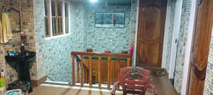 a hallway of a house with a brick wall at indrapuri homestay in Darjeeling
