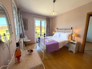 a bedroom with a bed with a purple blanket at Sunlit Village Escape in Kompítsion