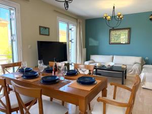 a dining room with a wooden table and chairs at Sunlit Village Escape in Kompítsion