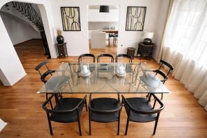 a glass table and chairs in a room at Apartment Vila Pavlovski in Bled