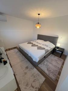 a bedroom with a large bed and a night stand at Avella House in Mühlheim