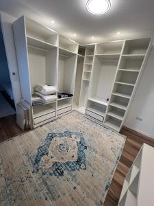 a room with white closets and a rug at Avella House in Mühlheim