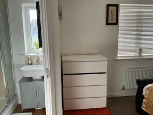 a bathroom with a sink and a white sink at Home away from away in Dartford +19 photos