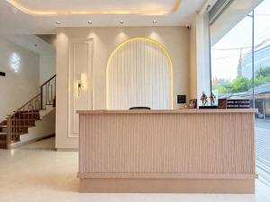 a lobby with a reception counter in a building at Sharda Grand in Ujjain