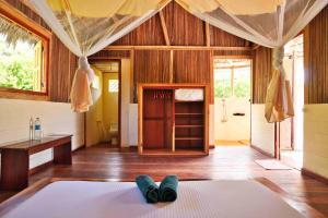 a room with a bed and a desk in it at Mazava Loha Resort in Antsiranana