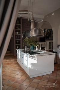 a kitchen with a white island in a room at Villa Arta in Drage +67 photos
