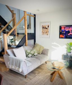 a living room with a couch and a glass table at Rhubarb Cottage in Navan