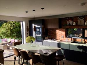 a kitchen with a table and some chairs in a room at Rhubarb Cottage in Navan