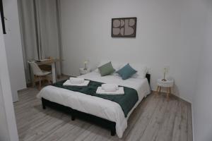 a bedroom with a large bed with two pillows at Casa Sangiorgio Srl in Treviglio +14 photos