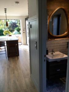 a bathroom with a sink and a mirror at Rhubarb Cottage in Navan +22 photos