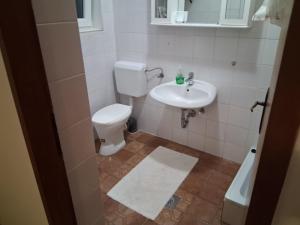 a bathroom with a toilet and a sink at Kampor 211 in Kampor