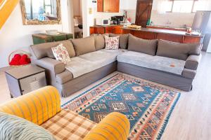 a living room with a couch and a rug at Whitehouse- Hot Tub in Elands Bay +12 photos