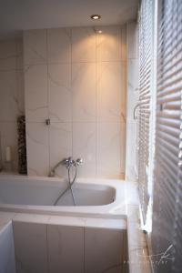 a white bath tub in a bathroom with a window at Villa Arta in Drage