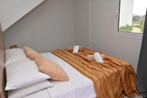 a bedroom with a large bed with two pillows at Olympus Pool Retreat in Katerini