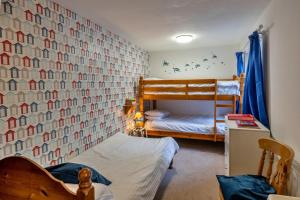 a bedroom with two bunk beds and a wall at Finest Retreats - Trimstone Manor, Manor Cottage in Woolacombe +23 photos