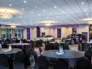 a room with tables and cars parked in it at Mercure Northampton in Northampton