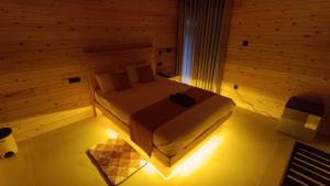 a bedroom with a bed in a wooden room at Wood Gold Ella in Ella