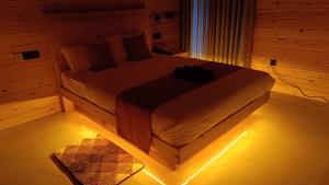 a bedroom with a bed with lights on the floor at Wood Gold Ella in Ella +3 photos