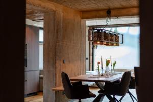 a dining room with a table and chairs and a chandelier at Lodge 53 in Breitenwang