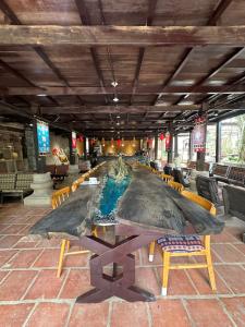 a large lobby with a large table and chairs at Loopmoto Riverside Homestay in Làng Lap