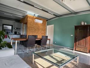 a living room with a glass table and chairs at Private Apartment Retreat in Breda