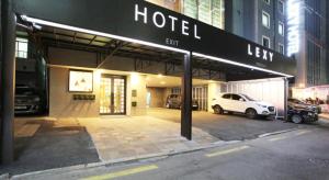 a hotel with cars parked in a parking lot at 렉시호텔 in Seoul