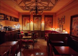 a restaurant with a dining room with tables and chairs at Hotel De La Paix in Lille
