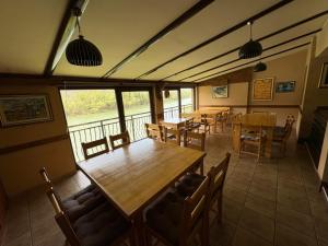 a dining room with tables and chairs and windows at Konaci kod Bobe in (( Vratna ))