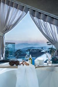 a room with a window with a view of the mountains at Zenora Hillside Garden in Da Lat