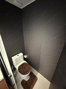 a bathroom with a white toilet in a stall at Lionheart Roslyn Suite 2 in Nuku‘alofa