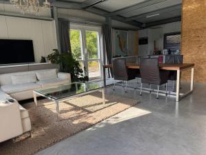 a living room with a couch and a table at Private Apartment Retreat in Breda