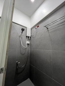 a shower stall in a bathroom with a glass door at Wanderers Backpacker Condotel in Pusok