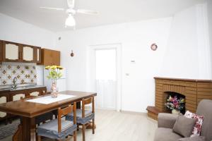a kitchen and dining room with a table and a fireplace at Alta Marea in Fossacesia +7 photos