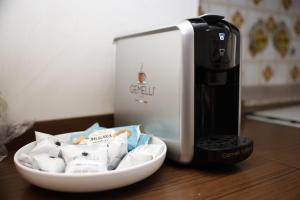a coffee machine sitting on a table next to a bowl at Alta Marea in Fossacesia