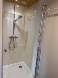 a shower with a glass door in a bathroom at Private Apartment Retreat in Breda +18 photos