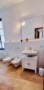 a bathroom with two sinks and a toilet and a mirror at lucia in Bellagio +38 photos